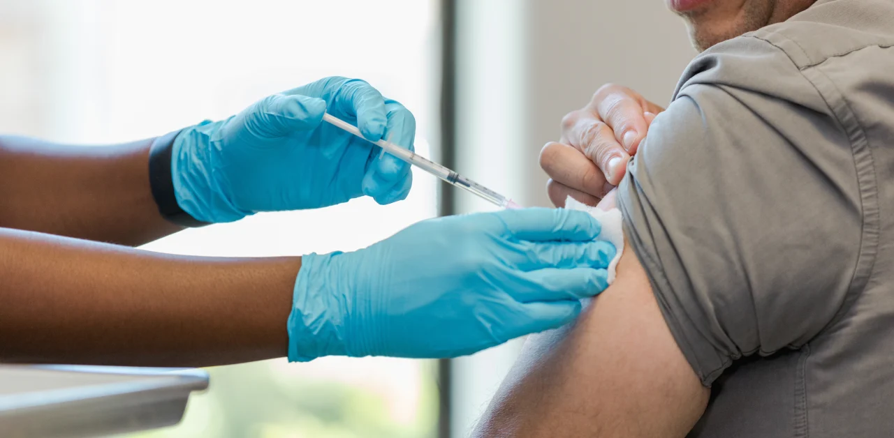 A patient receiving a shot in the arm.