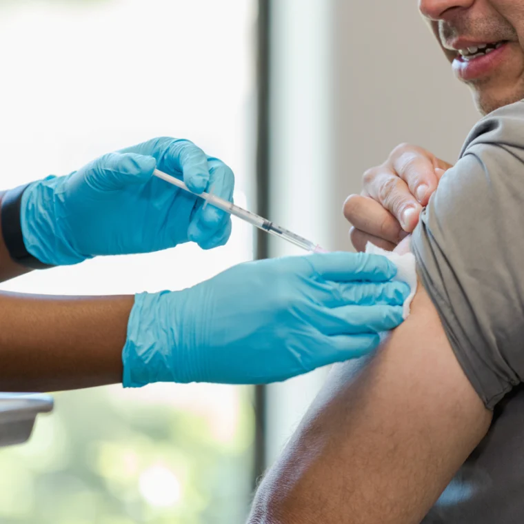 A patient receiving a shot in the arm.